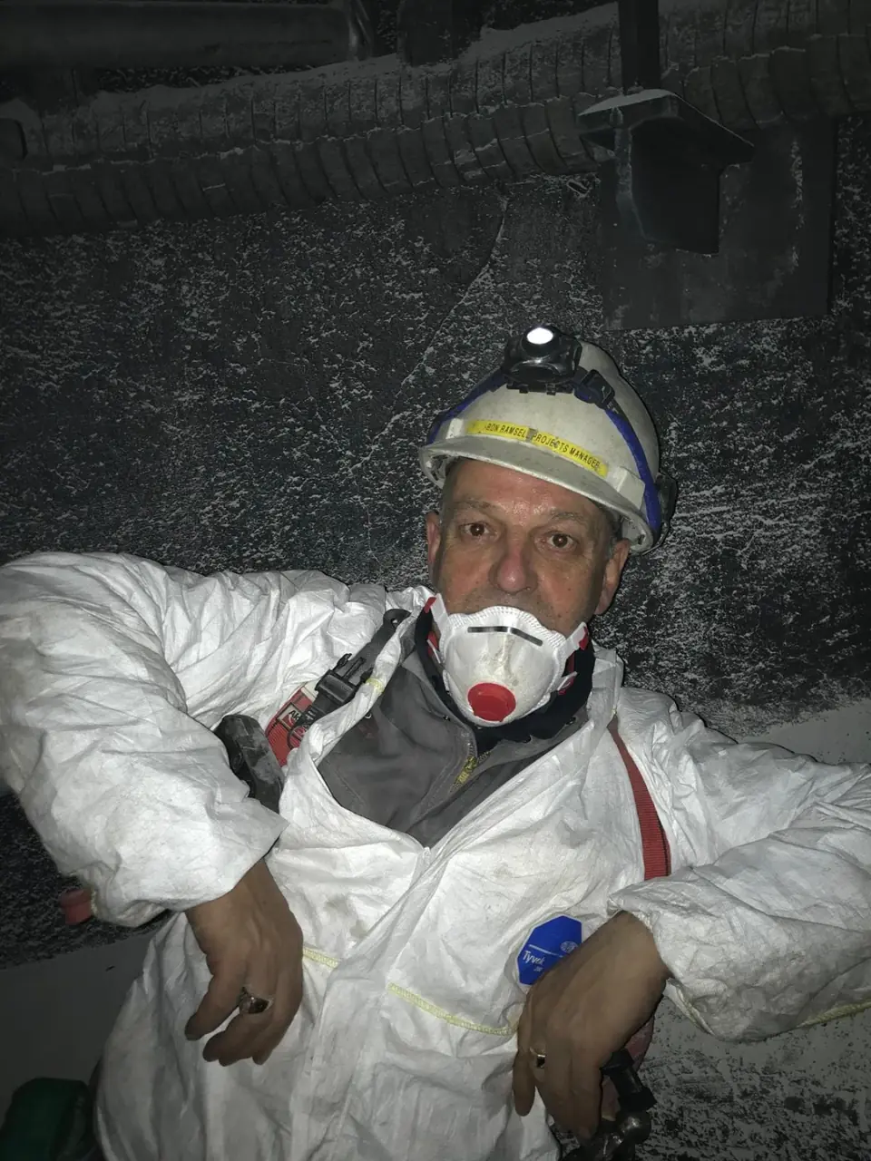 Ron Ramsell on site in protective overalls and helmet